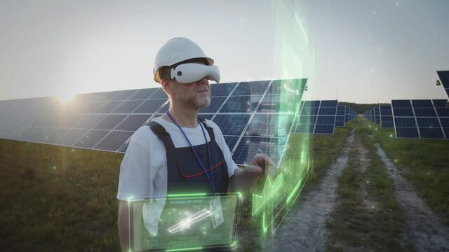 Old experienced engineer wearing VR glasses touch interactive hologram interface controlling solar panel energy production. Transformation, conversion, storage output efficiency transfer calculator