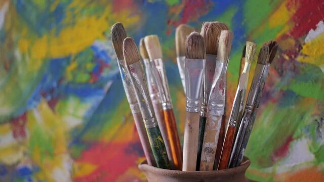 Paint brush in clay jug on table background texture. Paintbrush  painting and art still life. Abstract art concept