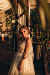 Portrait of the bride in the evening sun. Photoshoot at sunset.