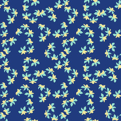 Tropic seamless pattern with random yellow hawaii flowers silhouettes. Navy blue background. Bright design.