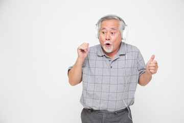 Senior Asian man listening favourite music with headphones isolated on white background