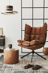 Modern interior of living room with design brown armchair, side table, pendatn lamp, loft wall,...