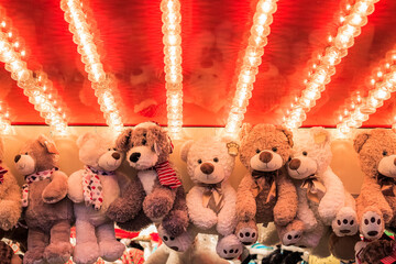 Stuffed toy bears on display awarded as winning prizes at Christmas funfair winter wonderland in...