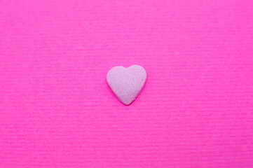 Pink heart on pink background. Saint Valentine's day concept. Love and romantic photo. Postcard for holiday. Beautiful warm wallpaper with love. Soft focus. Copy space.