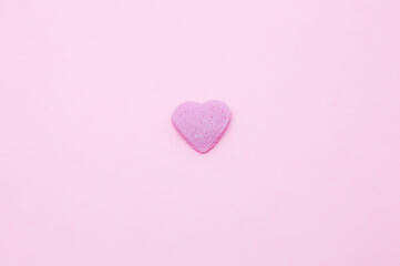 Pink heart on pink background. Saint Valentine's day concept. Love and romantic photo. Postcard for holiday. Beautiful warm wallpaper with love. Soft focus. Copy space.