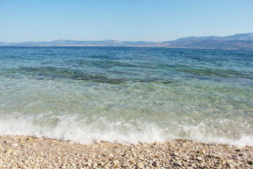 Pebbles beach with waves