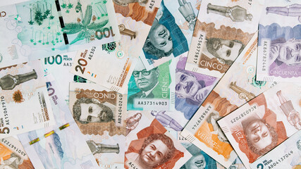 Colombian money of different denominations on white background - obrazy, fototapety, plakaty