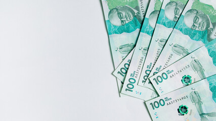 colombian money, one hundred thousand pesos on white background - obrazy, fototapety, plakaty