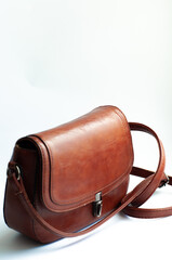 a small brown leather handbag isolated on white background. fashionable leather bag handmade. ladies bag. fashion style.