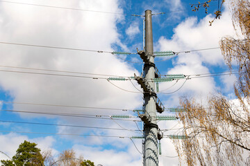 Steel tower of power lines in the background of clouds. Technological concept.