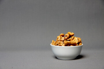 a bowl of walnut isolated on gray background - healthy eating concept