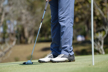 Golfers are putting golf in the evening golf course golf backglound. Golfer hitting golf ball....