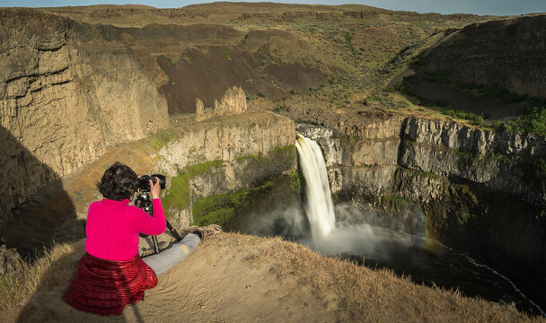 Girl taking photo of Palouse Falls in Washington State Park - Powered by Adobe