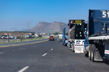 Fototapeta na wymiar trucks on the highway with mountains