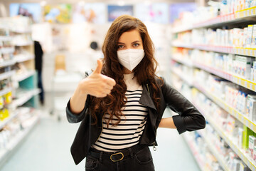 Frau mit Maske - Mund-Nasenschutz beim Einkaufen in einem Drogerie-Markt, Maskenpflicht