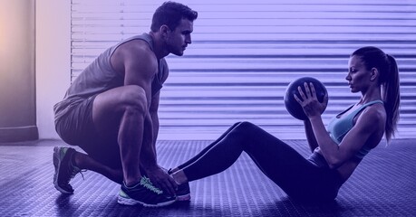 Composition of athletic man and woman exercising over light blur