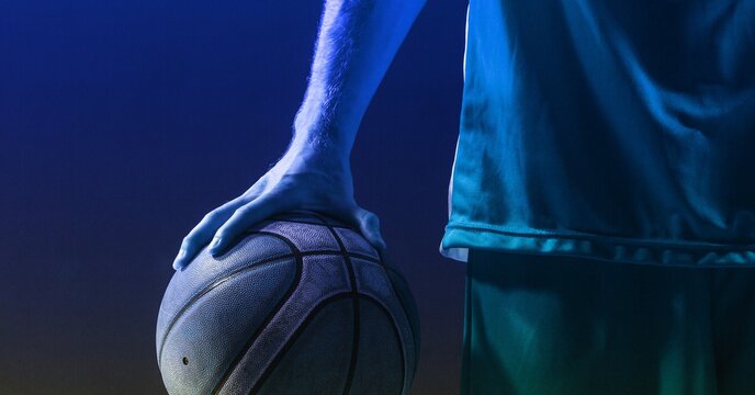 Composition of athletic male basketball player with ball on blue background