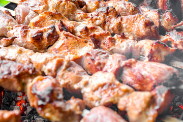 Skewers of pork. Fried pork meat cooked over burning coals.