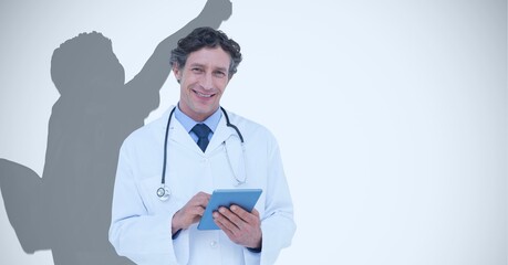 Composition of smiling male doctor and male athlete shadow with copy space on white