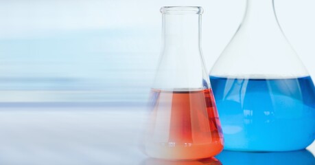 Composition of two flasks with red and blue liquid with motion blur