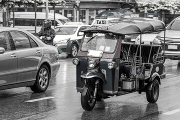 Black and white picture of driving tuk tuk Bangkok Thailand.