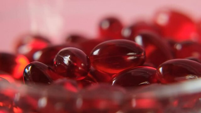 Krill oil gelatin capsules close-up  on a pink background. Rotation.omega fatty acids.Natural supplements