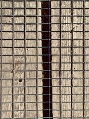 Square pattern background from wire mesh on wood