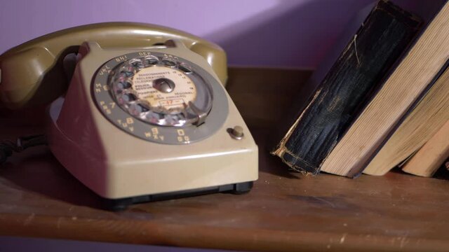 Vintage retro phone on book case