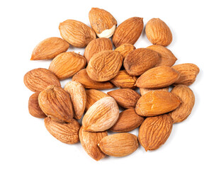 pile of of apricot kernels closeup on white
