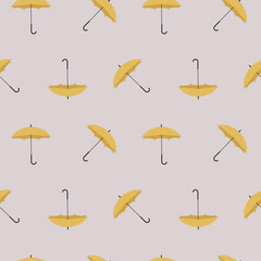 A seamless yellow umbrella pattern, weather theme, autumn and spring season