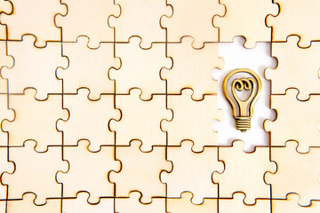 Jigsaw puzzle with a steel light bulb