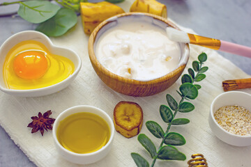 Homemade banana cosmetics. Cosmetic face mask with banana, oatmeal, honey, yolk. Natural skin care, wellness cosmetics,close-up. Diy banana mask,zero waste concept