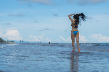 Portrait of young woman in bikini on tropical beach