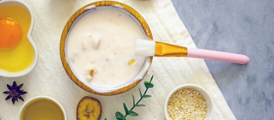 Homemade banana cosmetics. Cosmetic face mask with banana, oatmeal, honey, yolk. Natural skin care, wellness cosmetics,close-up. Diy banana mask,zero waste concept