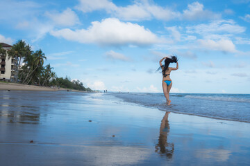 Portrait of young woman in bikini on tropical beach