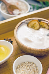 Homemade banana cosmetics. Cosmetic face mask with banana, oatmeal, honey, yolk. Natural skin care, wellness cosmetics,close-up. Diy banana mask,zero waste concept