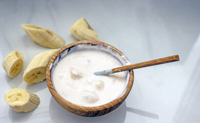 Homemade banana cosmetics. Cosmetic face mask with banana, oatmeal, honey, yolk. Natural skin care, wellness cosmetics,close-up. Diy banana mask,zero waste concept