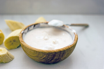 Homemade banana cosmetics. Cosmetic face mask with banana, oatmeal, honey, yolk. Natural skin care, wellness cosmetics,close-up. Diy banana mask,zero waste concept