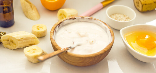 Homemade banana cosmetics. Cosmetic face mask with banana, oatmeal, honey, yolk. Natural skin care, wellness cosmetics,close-up. Diy banana mask,zero waste concept