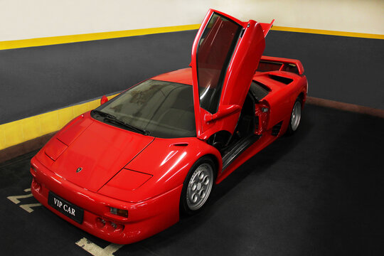 Kiev, Ukraine - May 22, 2021: Red Luxury Supercar Lamborghini Diablo Koenig With Open Door. Exclusive Red Supercar In The Underground Parking. Car Wallpaper