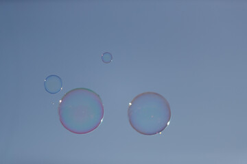 Fototapeta na wymiar soap bubbles on blue sky background