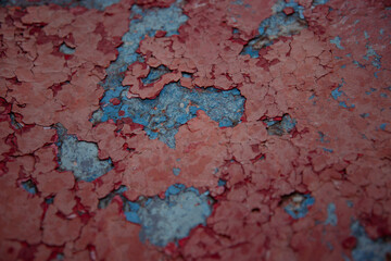 Rust texture. Corrosion of metal and peeling paint. The background is red.