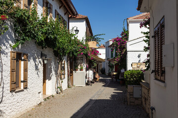 View of narrow street, traditional, old historical houses in famous, touristic Aegean town called 