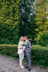 nice couple. wedding day of the bride and groom. newlyweds on a walk in the botanical garden. portrait of a girl and a guy. newlyweds in love