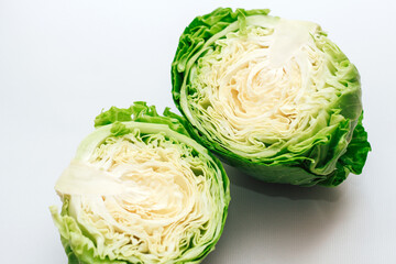 Young cabbage cut in half top view on gray background.