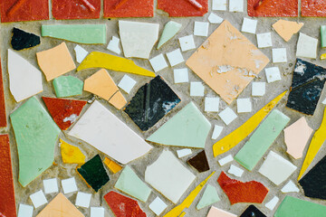 Texture background from mosaic old ceramic tiles. Colorful facade decoration.