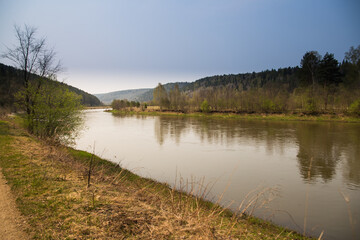 Ural mountain river Yuryuzan flows along rocks and taiga.