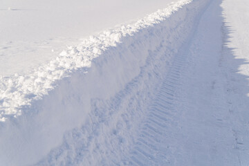 Fototapeta na wymiar drifts of snow in winter. snow trail after clearing the snow plow trail. season concept