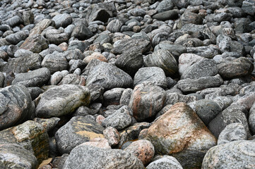 Abstract many large grey rocks, smooth and patterned texture. Authentic, on beach on Isle of Lewis,...