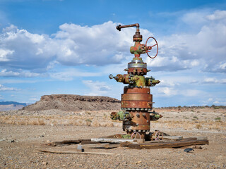 unused head of oil well with numerous valves in a desert landscape of central Utah - obrazy, fototapety, plakaty